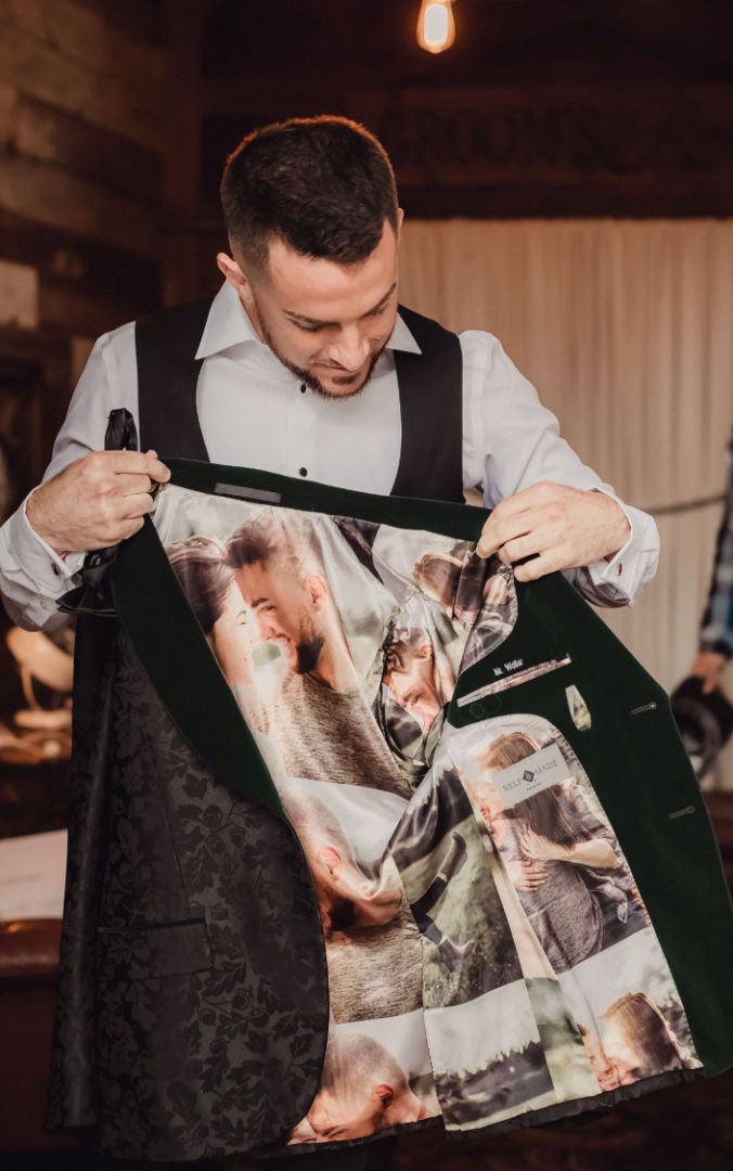 Person opening a jacket to show an illustrated custom lining