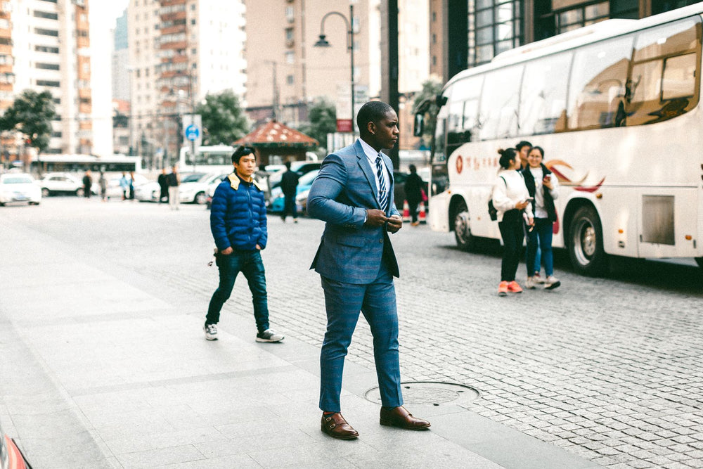 People wearing teal suits on a city street