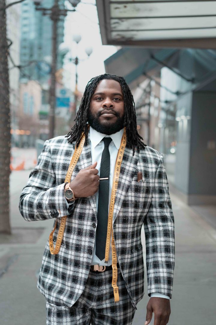 Person wearing a checked three-piece suit and tie outdoors