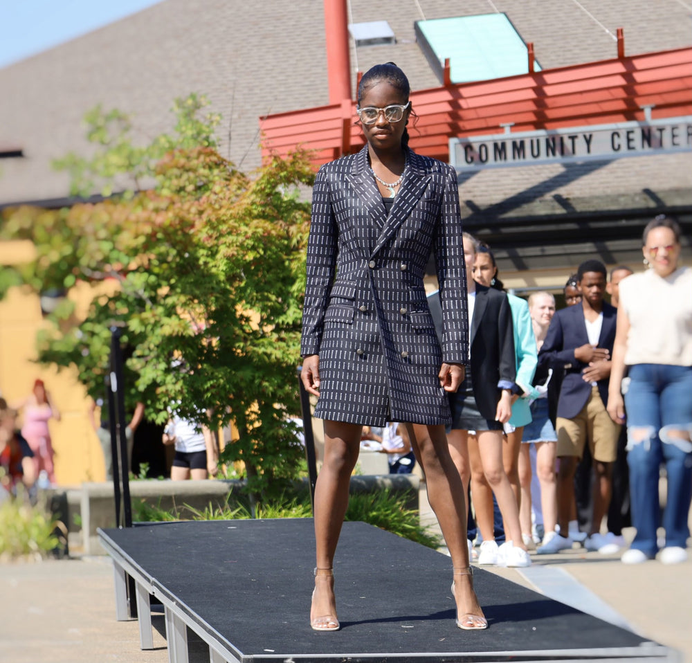 Model wearing a tailored outfit on an outdoor runway