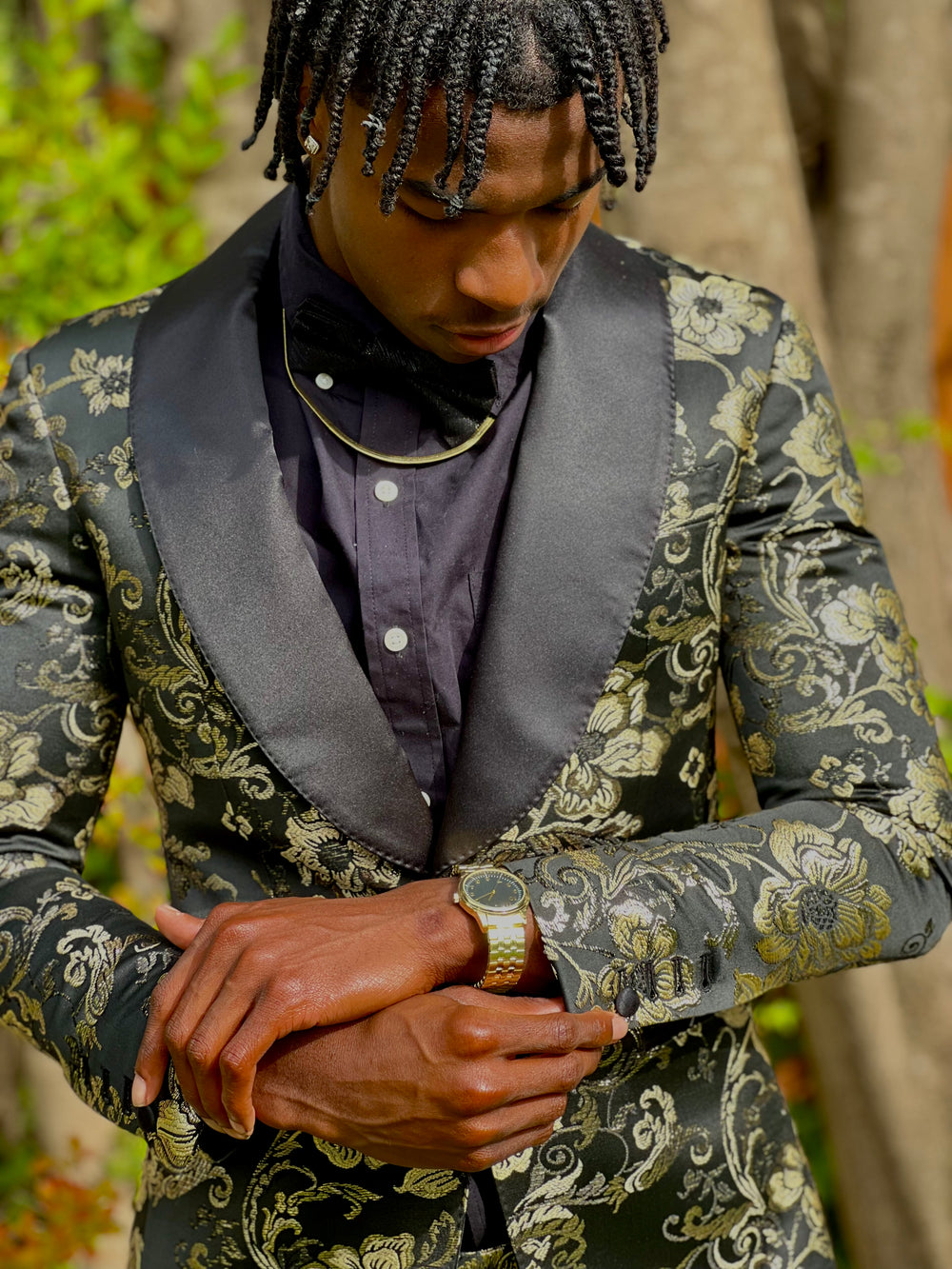 Person wearing a green patterned jacket with dark lapels